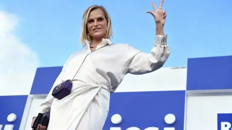 Una persona saluta con un gesto durante un evento televisivo all'aperto