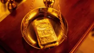 Lingotto d'oro posato su una bilancia dorata, simbolo del valore dell'oro usato